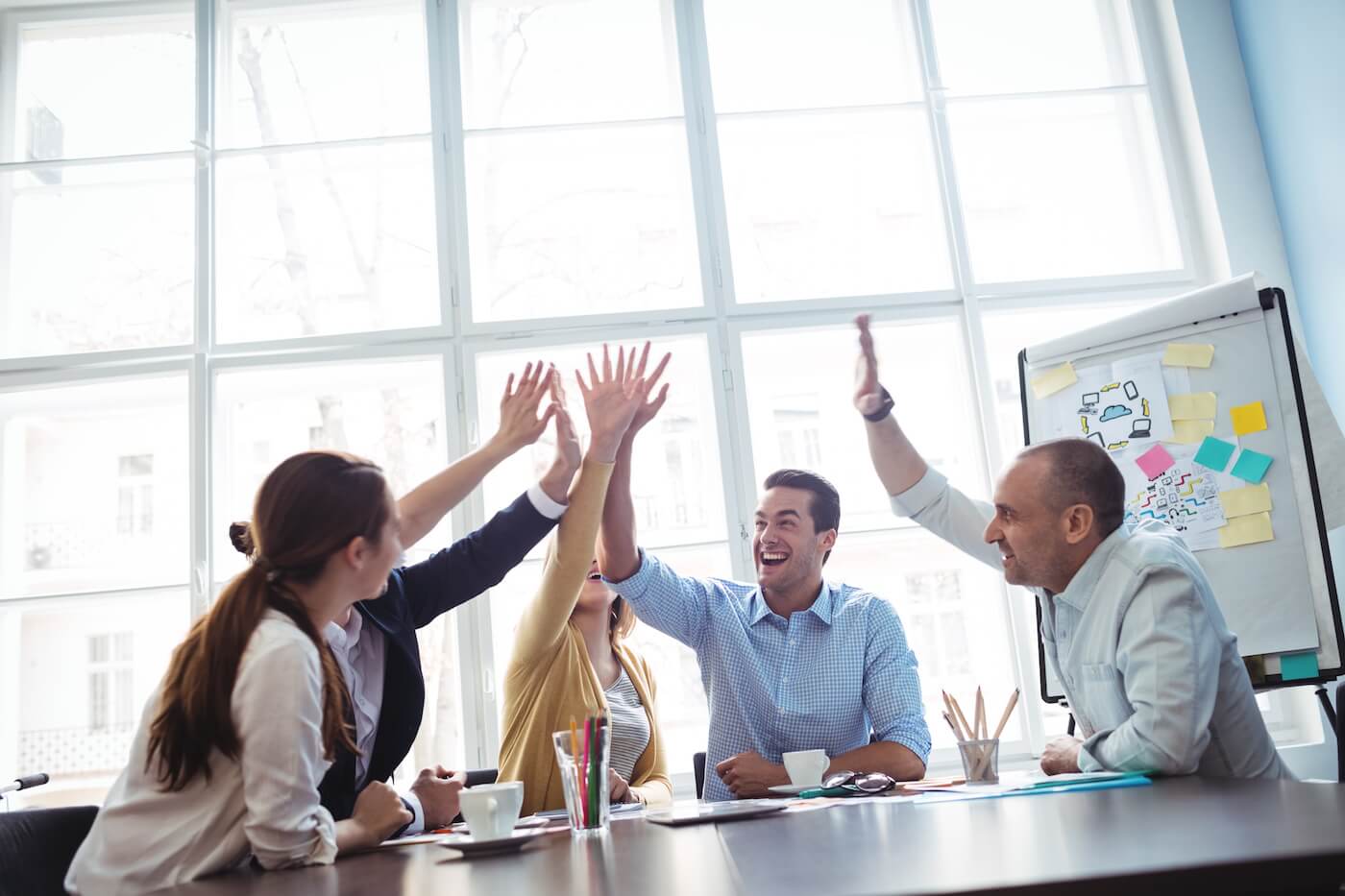 Coworkers celebrating a donor retention win