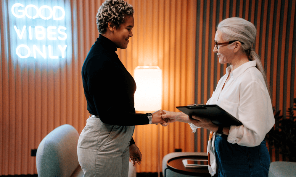Women shaking hands on granted corporate sponsorship