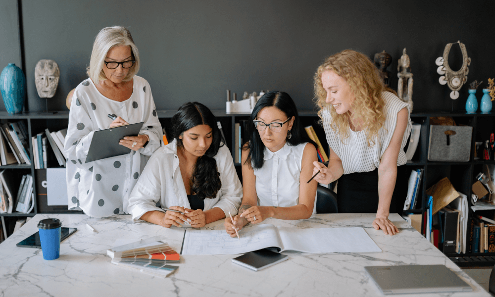 Group of women writing a a silent auction donation request letter