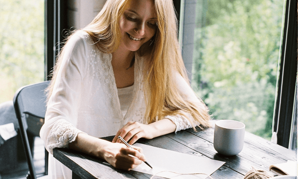 Young woman writing a donation letter request