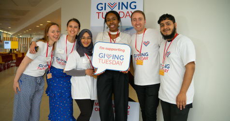 A group of people promoting Giving Tuesday matching donations 