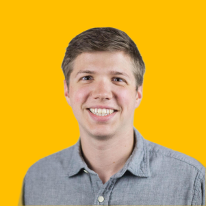 Russell's headshot against a yellow background