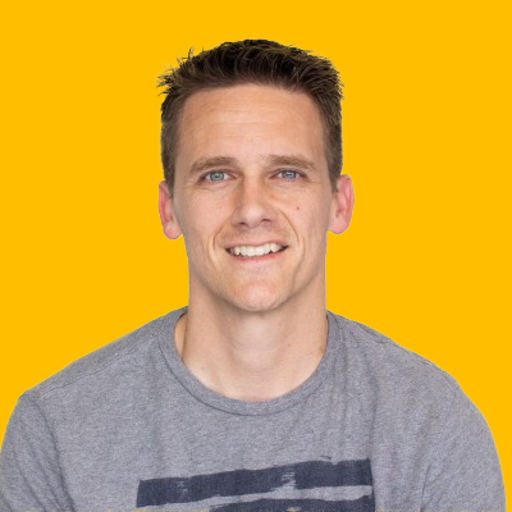 Tom Spindle's headshot against a yellow background