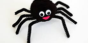 Black spider craft with googly eyes and pink mouth