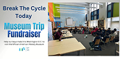 Students in a classroom with Museum Trip Fundraiser banner