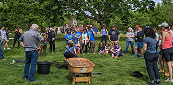 Volunteers around a wheelbarrow in a park